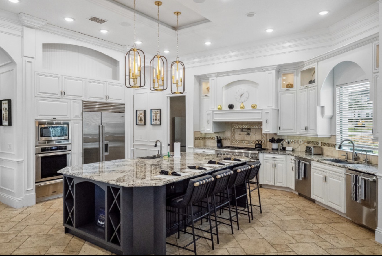 Large chef's kitchen with an island and seating