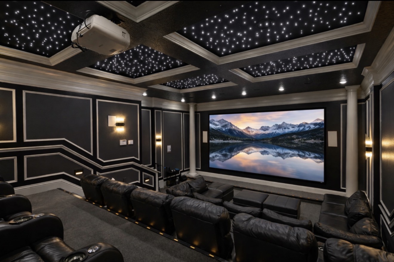Private home theater with reclining seats and a starlit ceiling